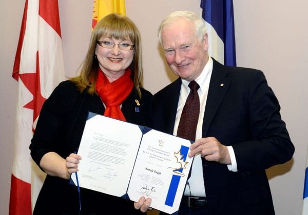 Brenda Daigle poses with the Governor General of Canada, David Johnston as she receives the Governor General Caring Canadian Award. Photo credit: Sgt Ronald Duchesne, Rideau Hall © Her Majesty The Queen in Right of Canada represented by the Office of the Secretary to the Governor General, 2015.