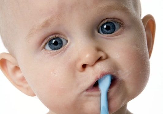 Baby with toothbrush