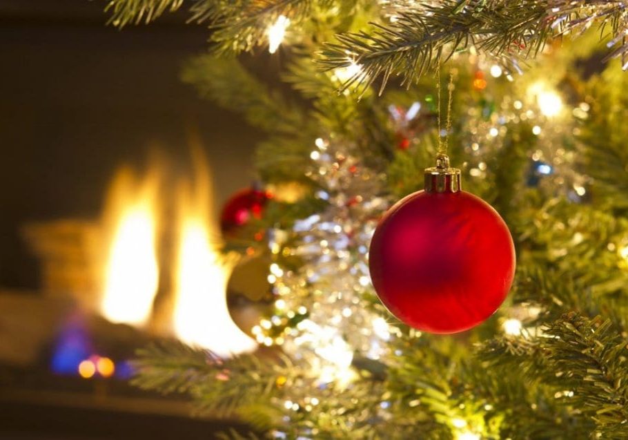 Bright red Christmas ornament hanging on Xmas Tree