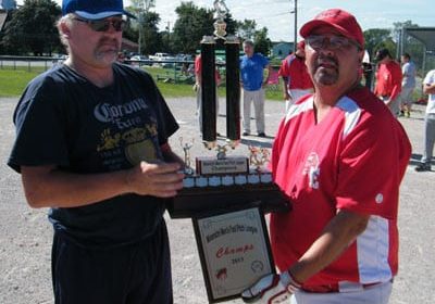 League Vice-President Mike McKenzie presents the championship trophy and plaque to Eel Ground Eagles player/coach Kelvin Simonson