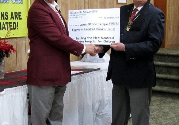 Noble Dave Bucklow, president of the Miramichi Shrine Club and Llewellyn Smith P.P., present a cheque for $1400 for Shriners Hospitals for Children.