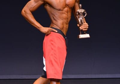 Adam Hambrook, owner of Sculpt Health & Fitness Miramichi being awarded NB Provincial Champion 2015 Men's Physique Short.