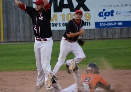 Spencer Stokes #9 steals second base as Tyler McKay leaps for the ball. Backing up the play is Gary Ryder as the Ironmen won 6-1 on Tuesday night. Photo by Brian Richard.