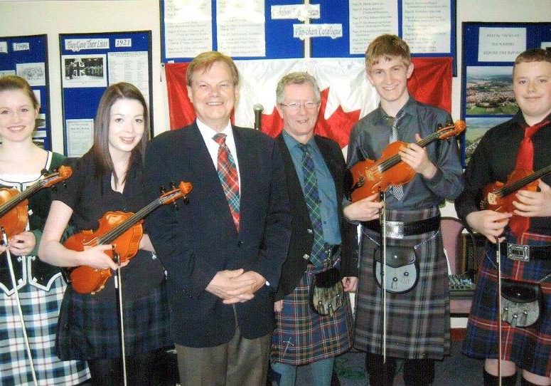 The Fochabers Fiddlers with John McKay, Past President of the Highland Society and James Alexander founder of the group. 