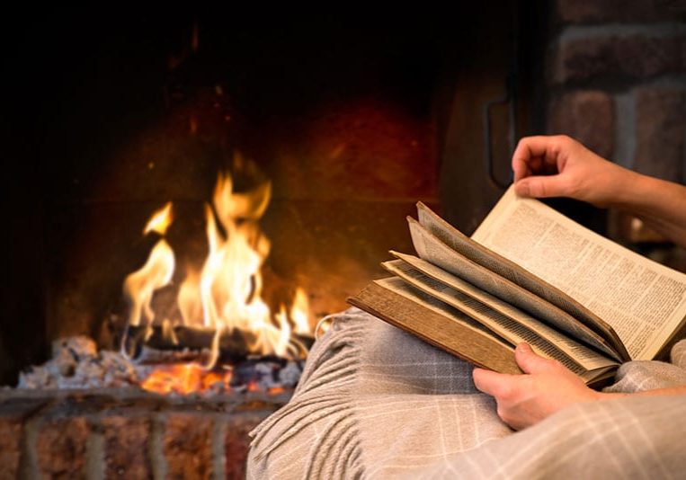 reading-book-by-fireplace