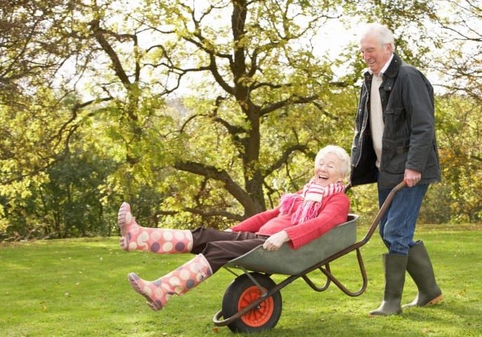 senior-couple-laughing-wheelbarrow-Small